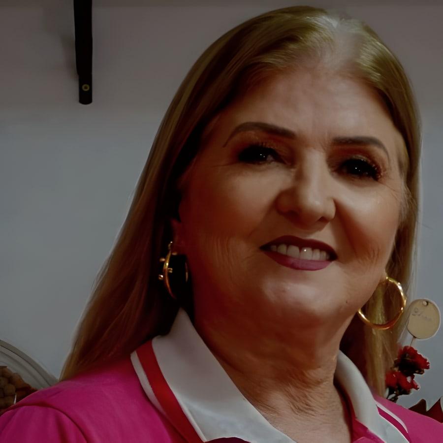 Luci, florista da JV, sorrindo na loja